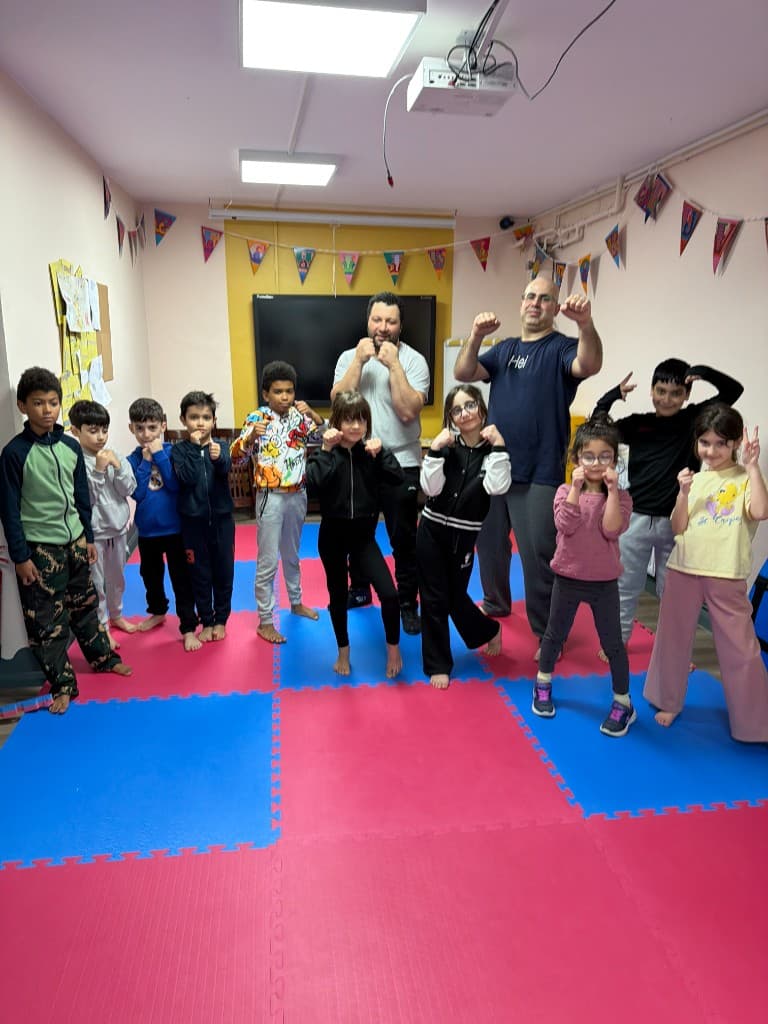 Unity of Migrant Workers’ta Little Champions dövüş sanatları oturumunda çocuklar ve eğitmenler