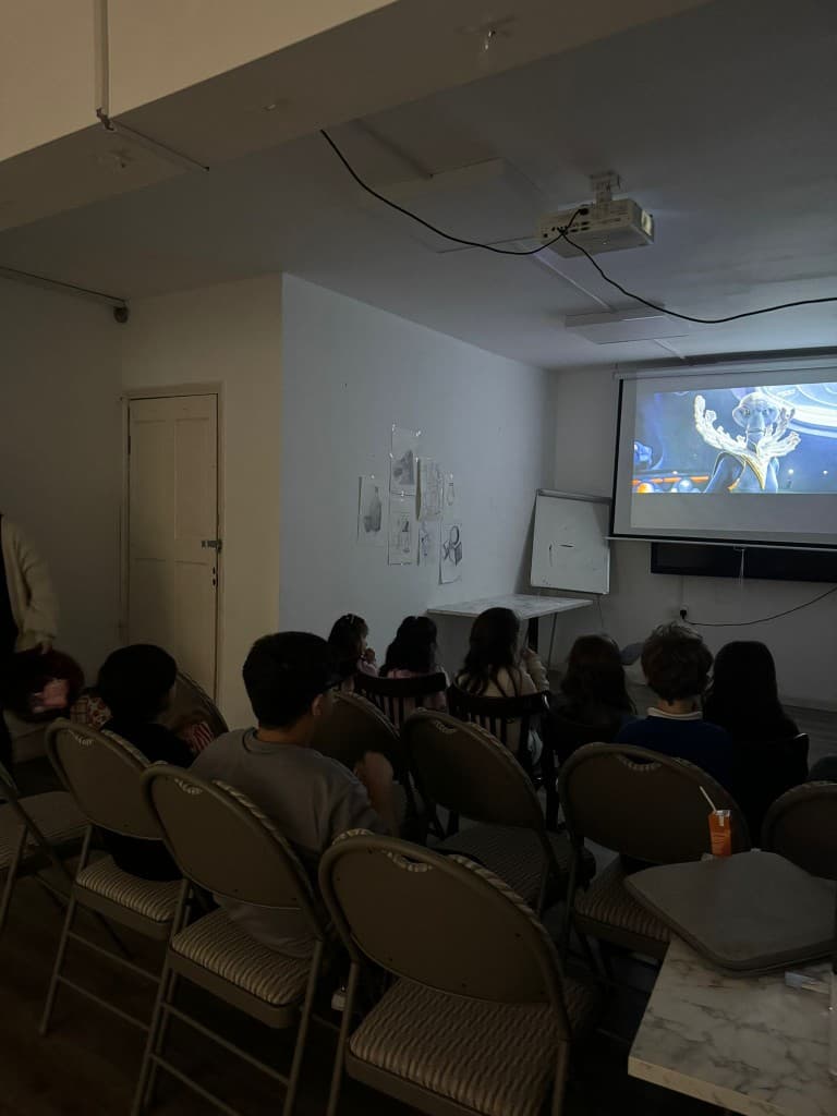 Children watching a film together at a UMW Tiny Humans movie night
